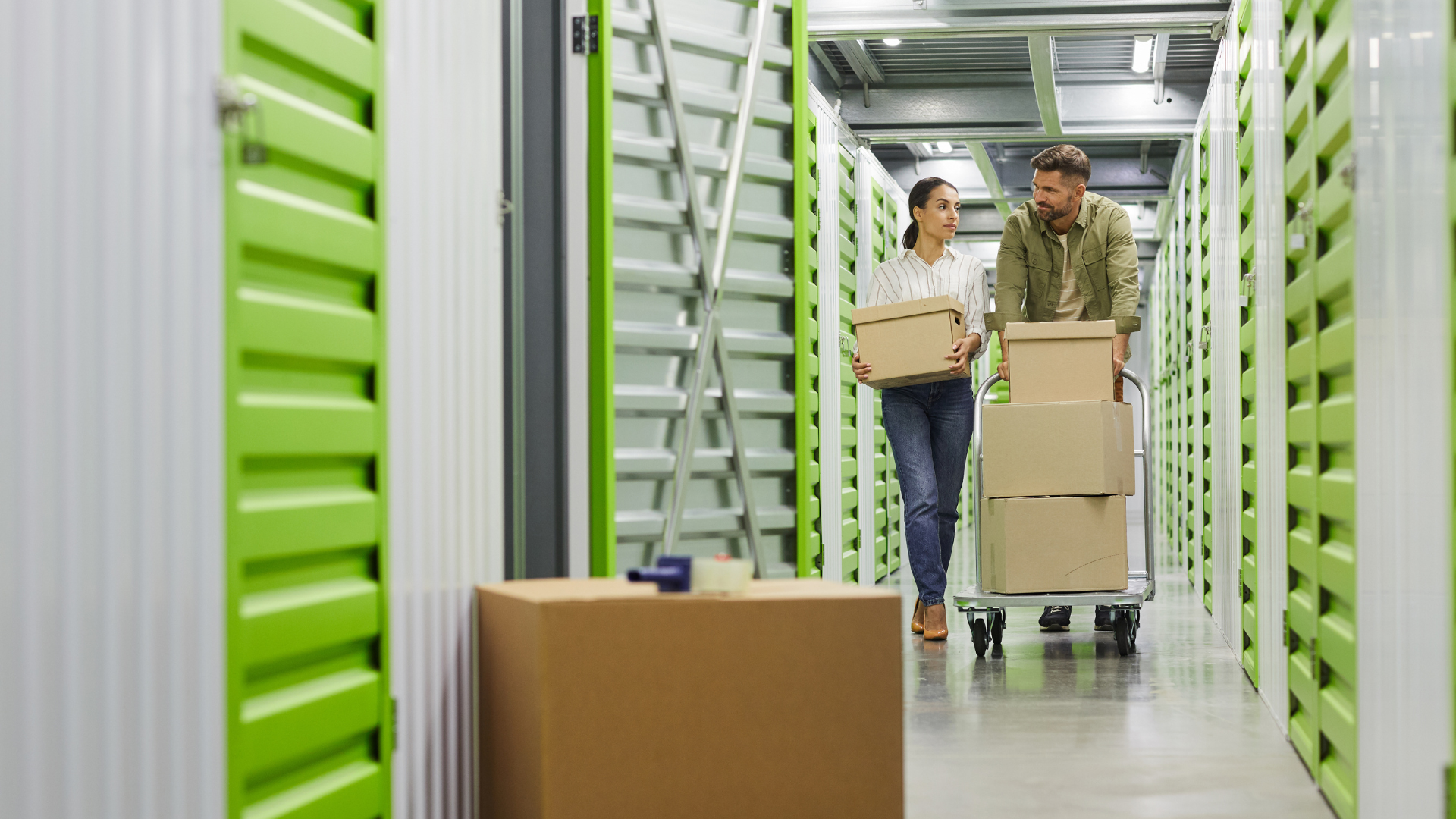 Couple moving boxes in storage unit