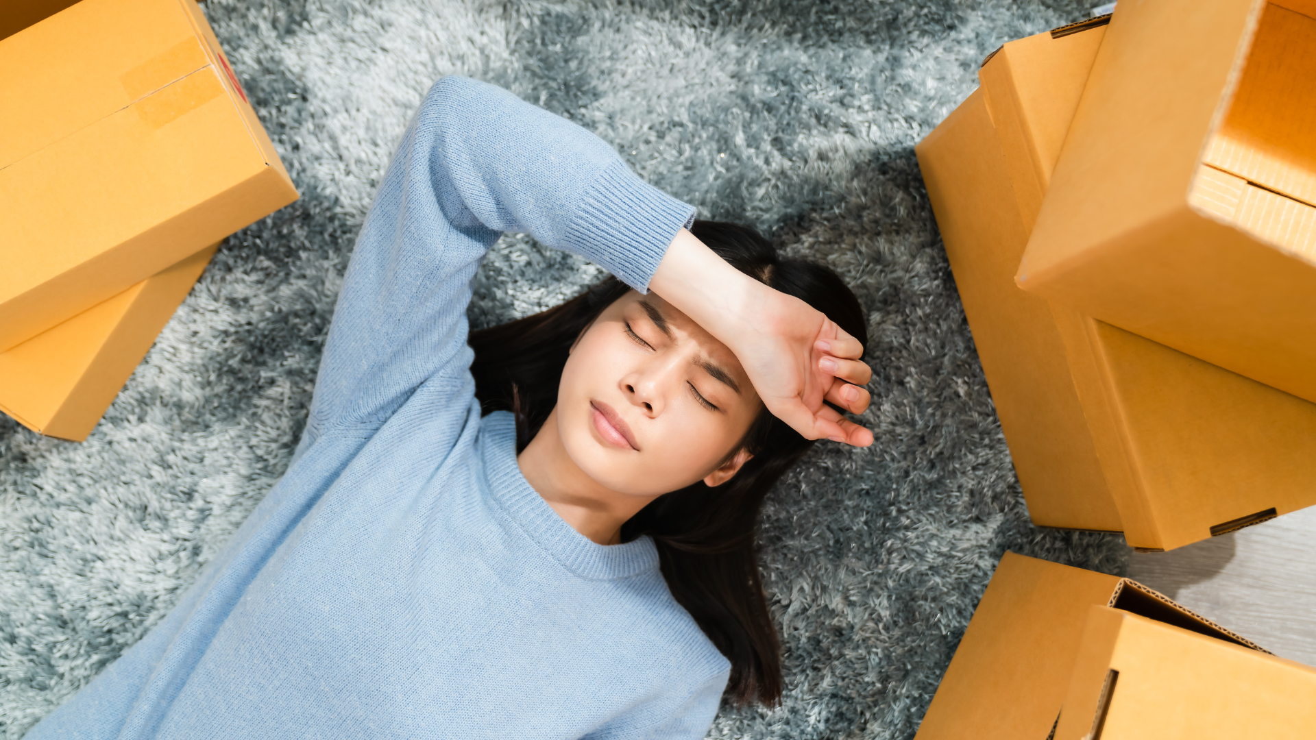 Stressed woman with moving boxes