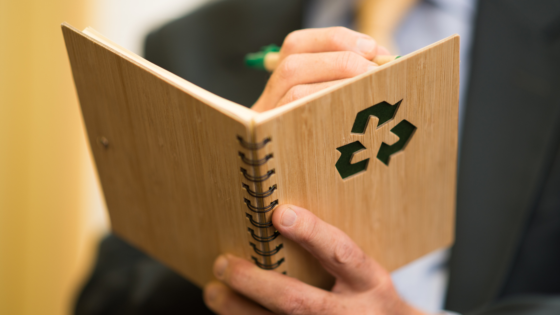Man listing down sustainable living guideline for more environmental move