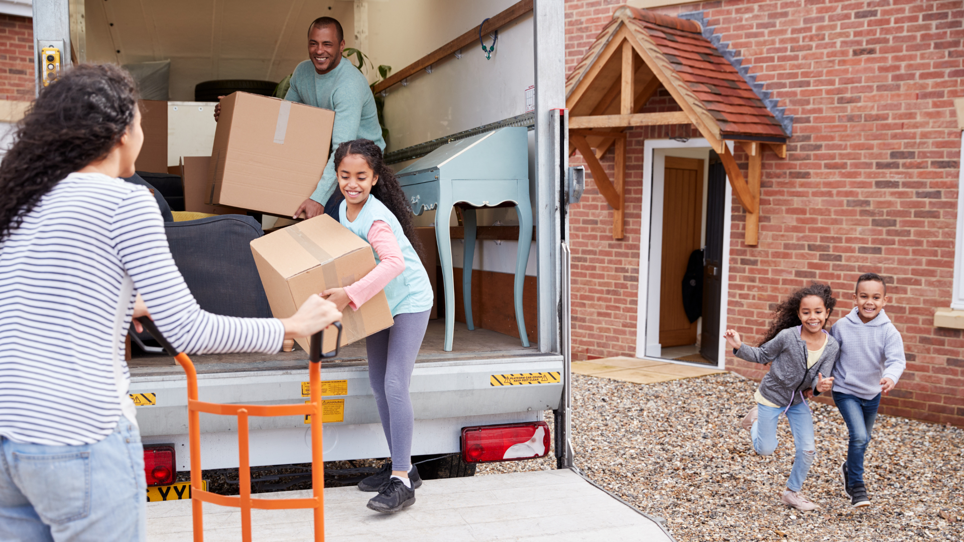 Family unloading furniture from moving truck
