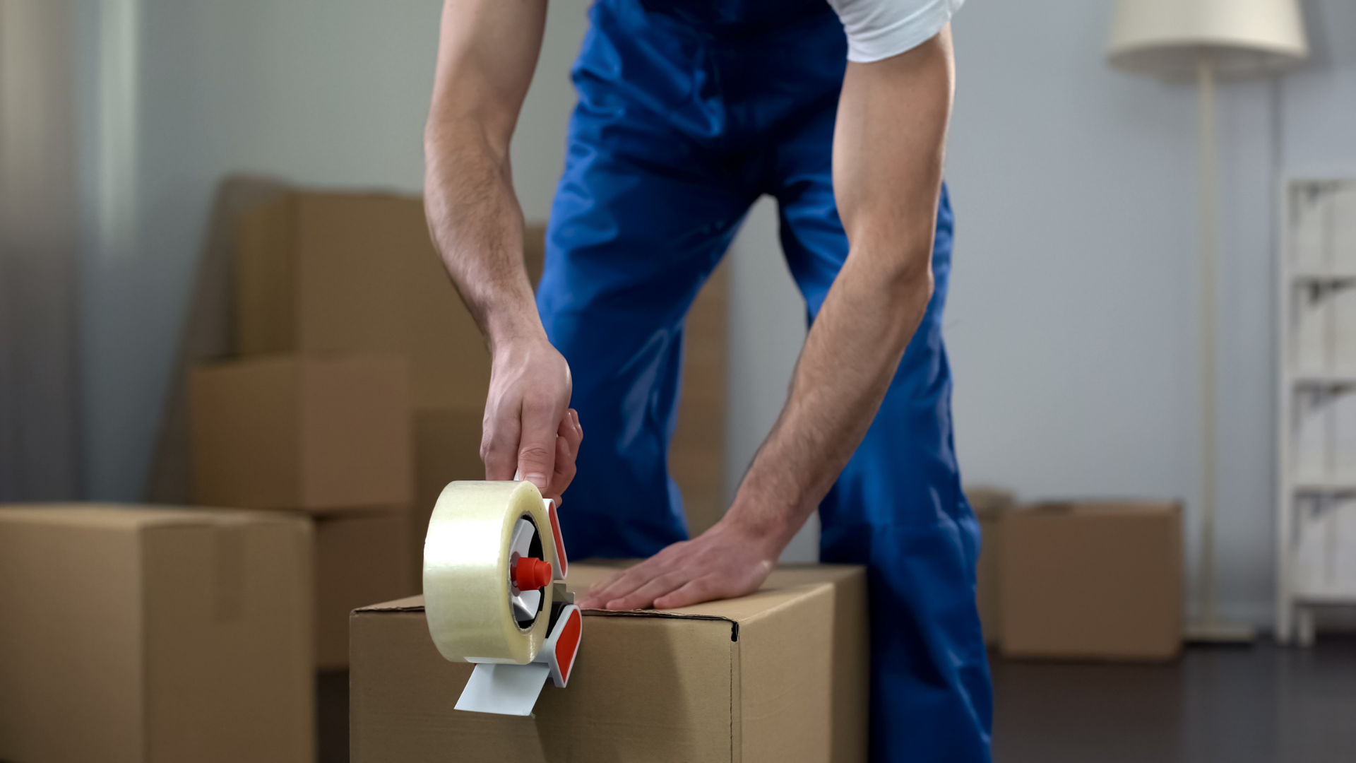 <img src=“mover packing boxes.png” alt=“mover packing a box with tape”>