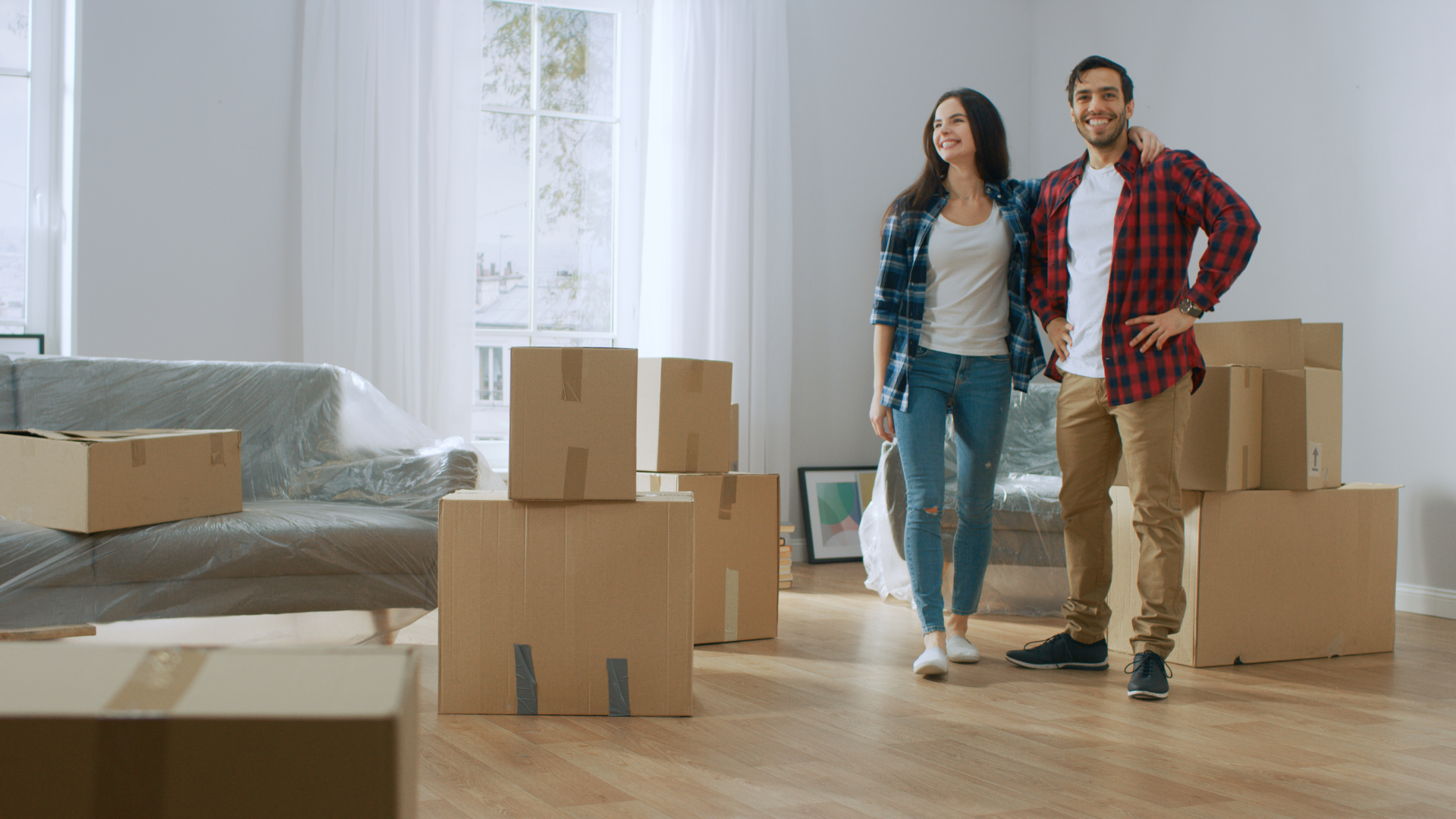 A couple ready to unpack things in their new place