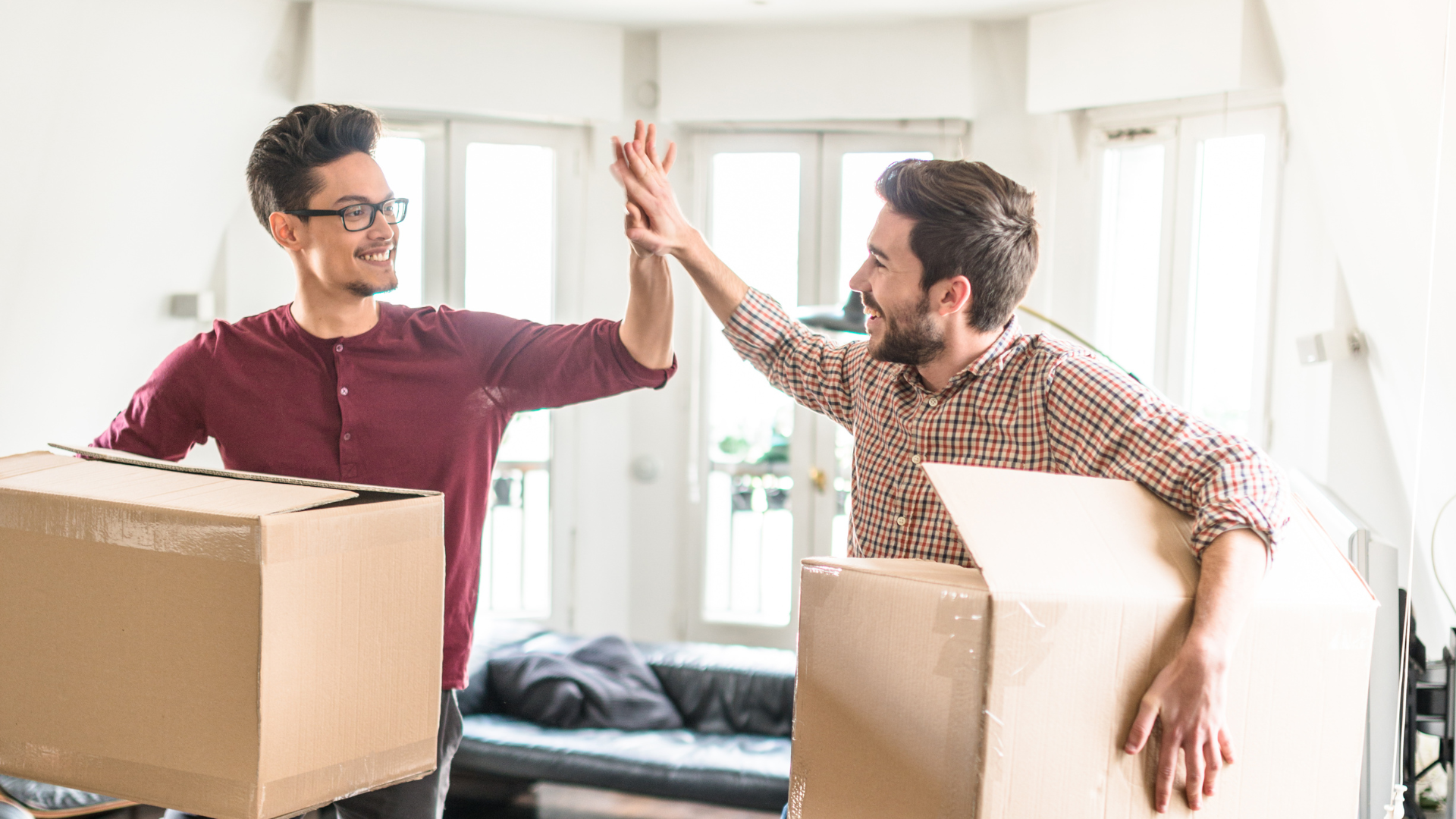 2 guys carrying boxes and ready to move out