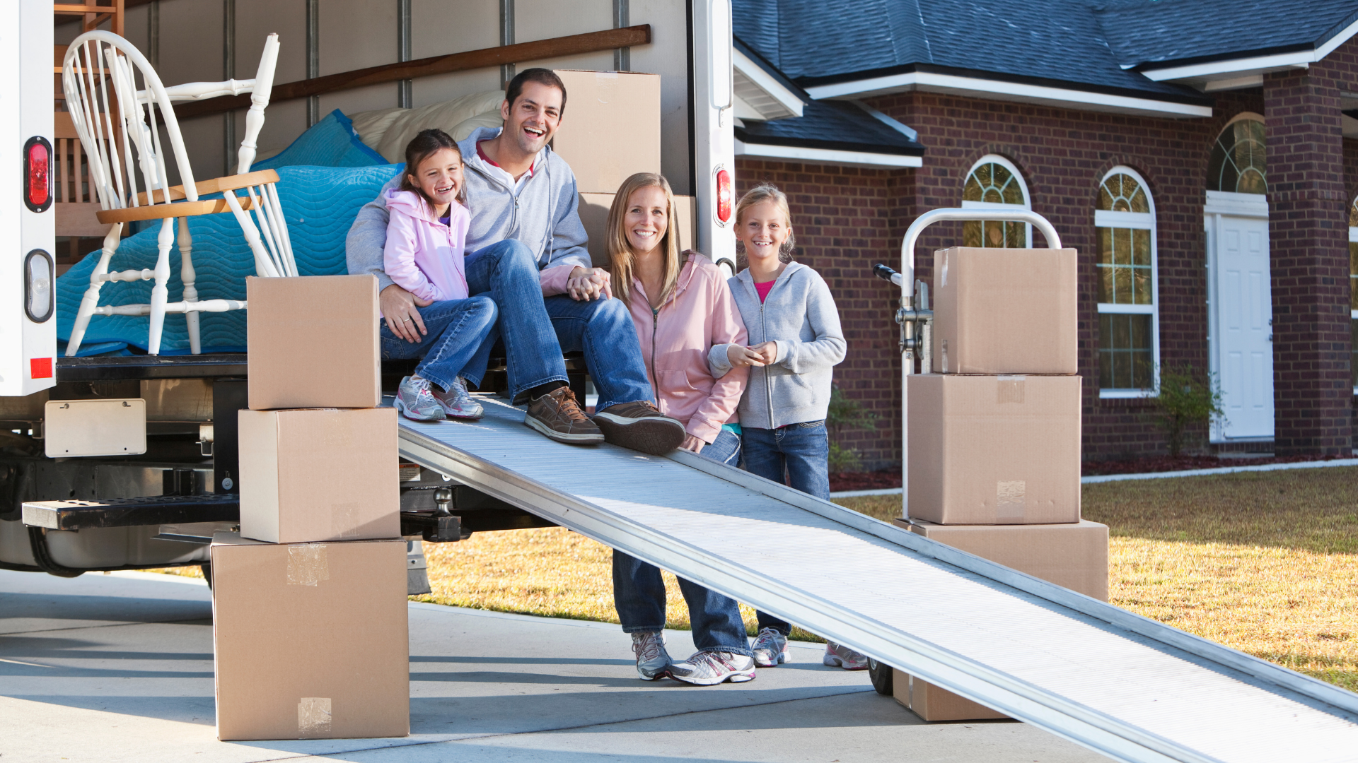 A family moving all the stuff from their old place, all the stuff are placed inside the truck.