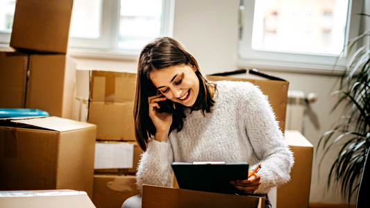 Woman listing down task list for her moving day