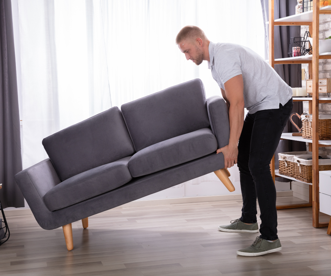 <img src=“man lifting a couch.png” alt=“man lifting a couch by himself in an apartment”>