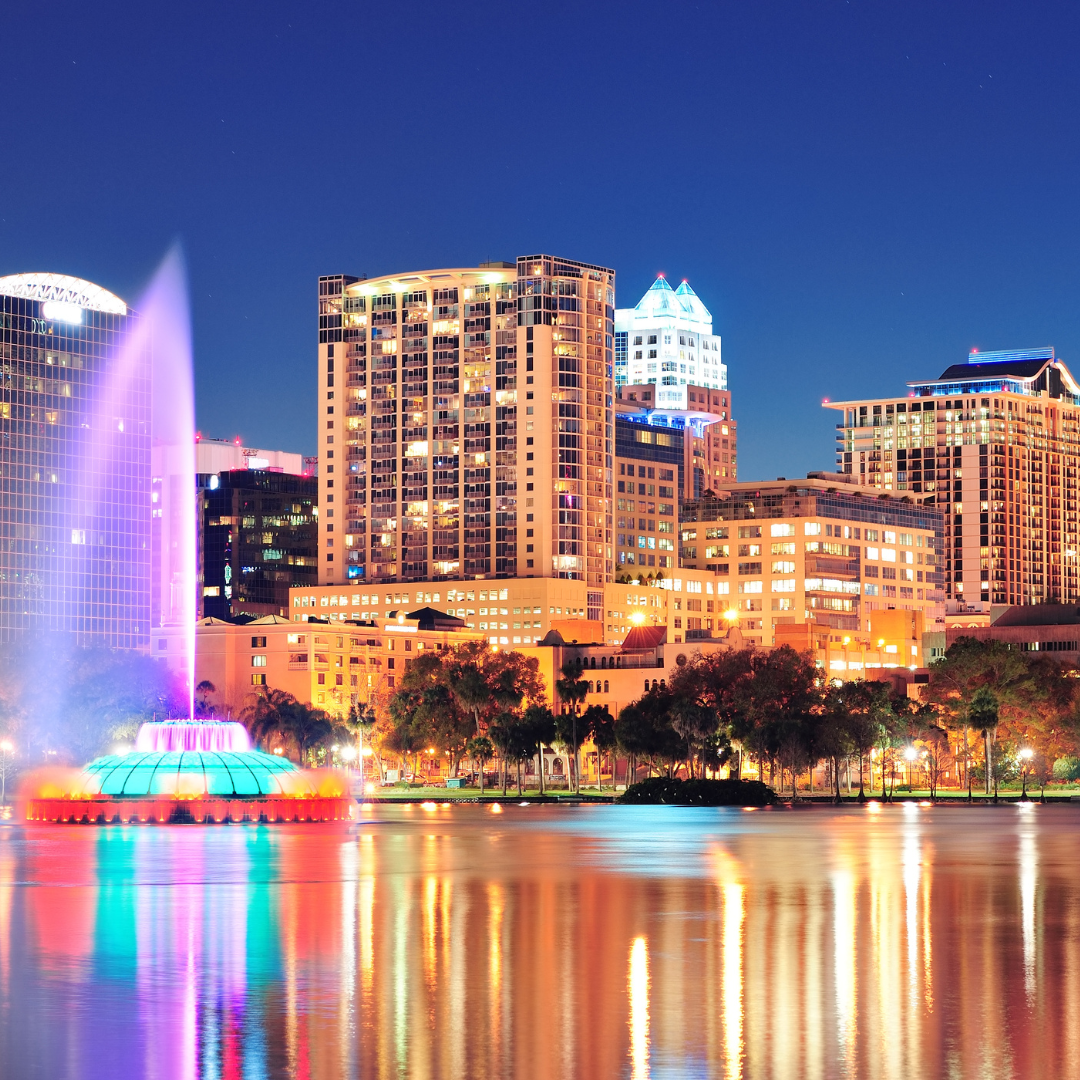 alt=”a stunning Orlando, FL skyline illuminated at night”