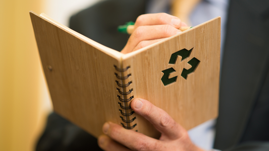 Man listing down sustainable living guideline for more environmental move