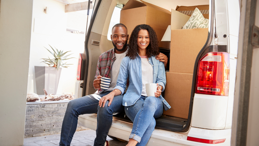 Happy couple having coffee on their moving day