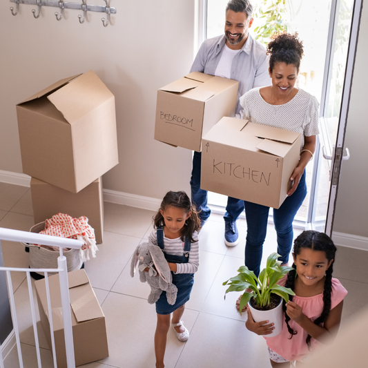 Family moving boxes into their new home