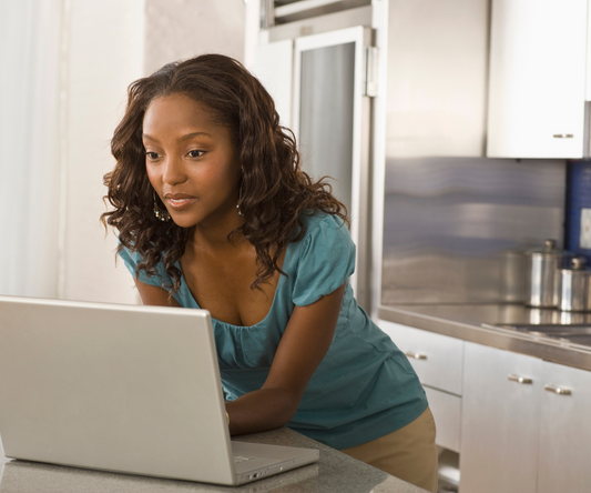 <img src=“Lady searching for movers.png” alt=“Lady standing in kitchen searching for movers on laptop”>