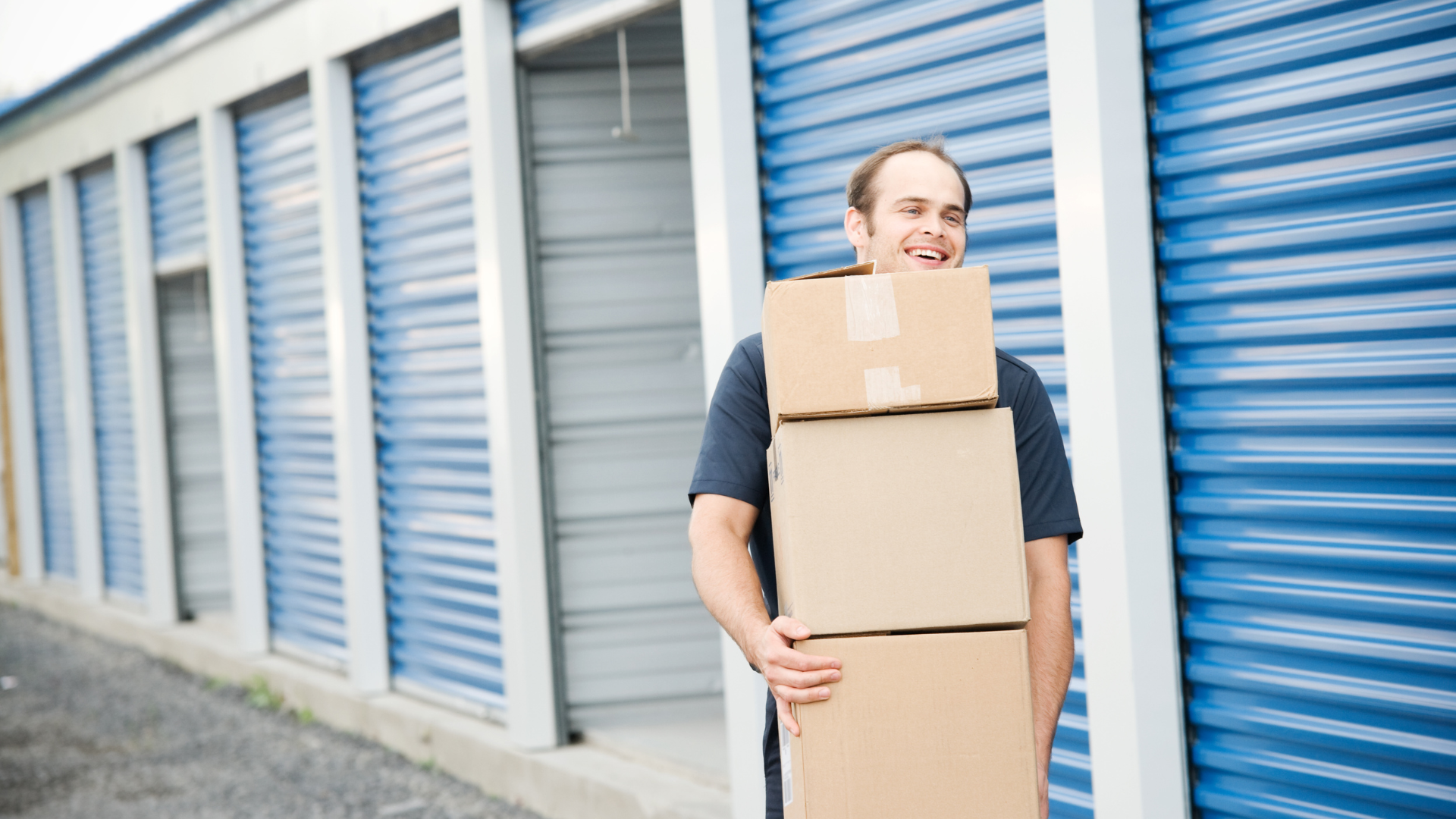 <img src=“Carry boxes storage unit.png” alt=“Man carrying boxes outside of a storage unit”>