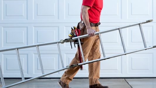 <img src=“Man walking with ladder.png” alt=“Man walking outside home with a ladder in hand”>