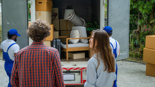 Happy couple with moving boxes at new house