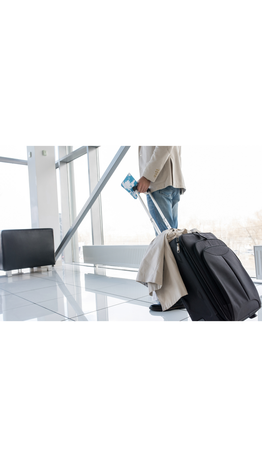 alt="a man with a black luggage"